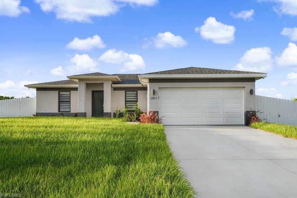 Image 1: Prairie-style home with stucco siding, concrete driveway, and a garage