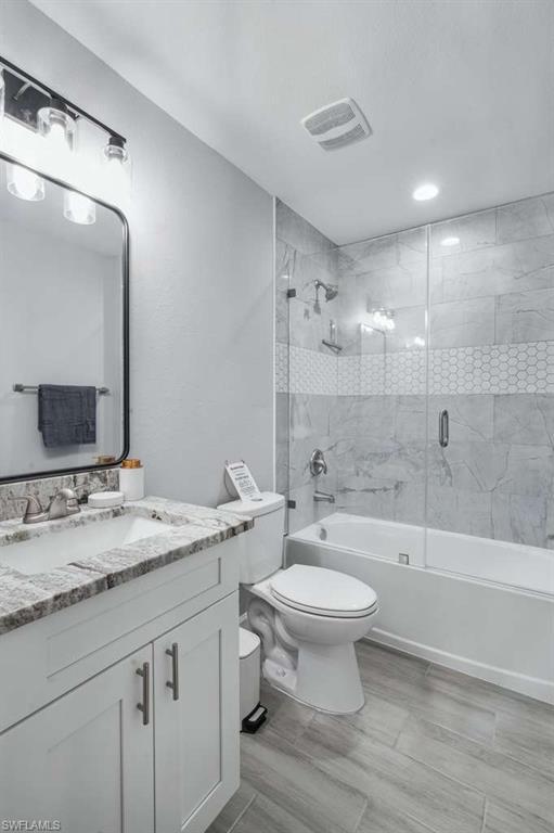 Image 4: Full bathroom featuring combined bath / shower with glass door and vanity