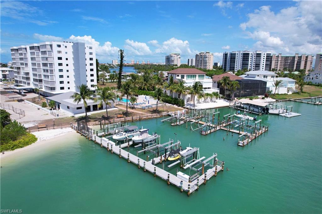 Image 2: Waterfront property featuring a private beach, multiple boat slips, and a multi-story building