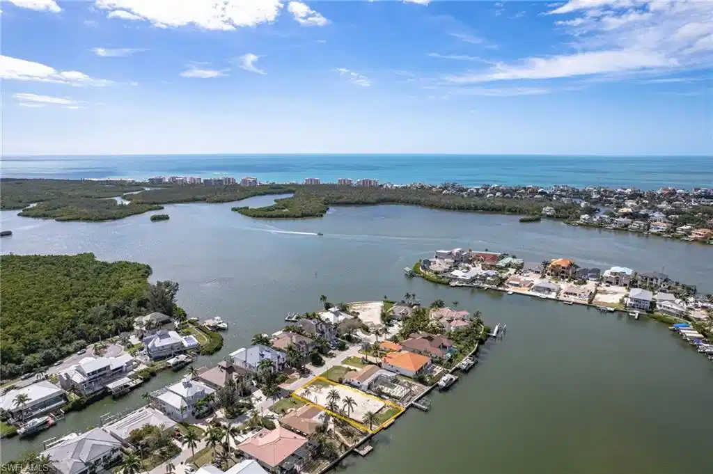Image 1: Aerial perspective of suburban area with a large body of water