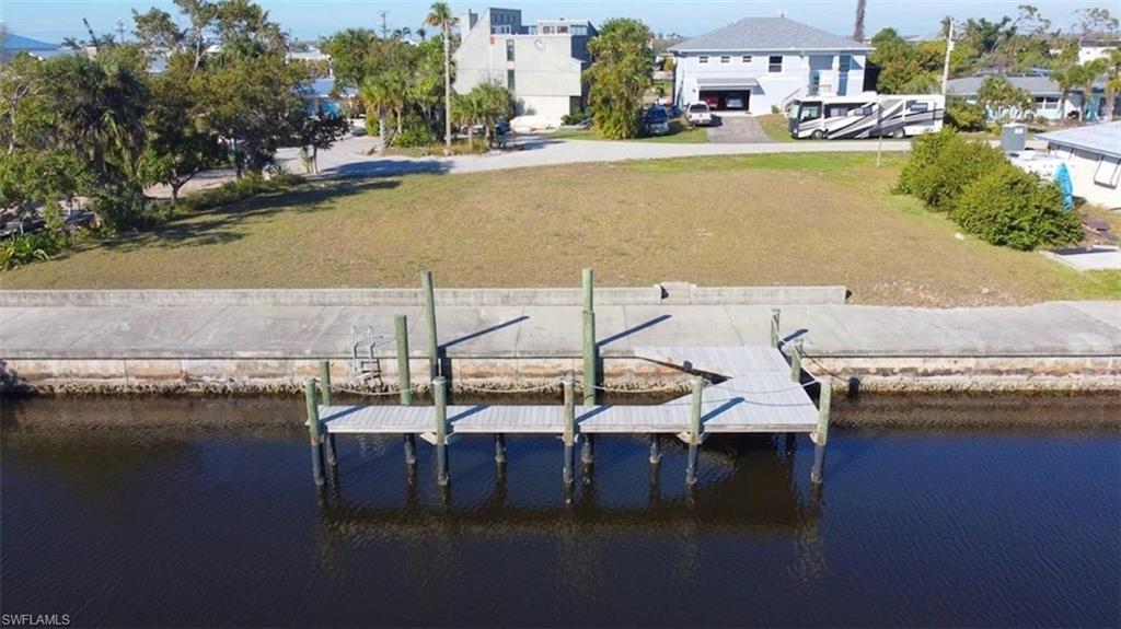 Image 1: View from water towards property and dock