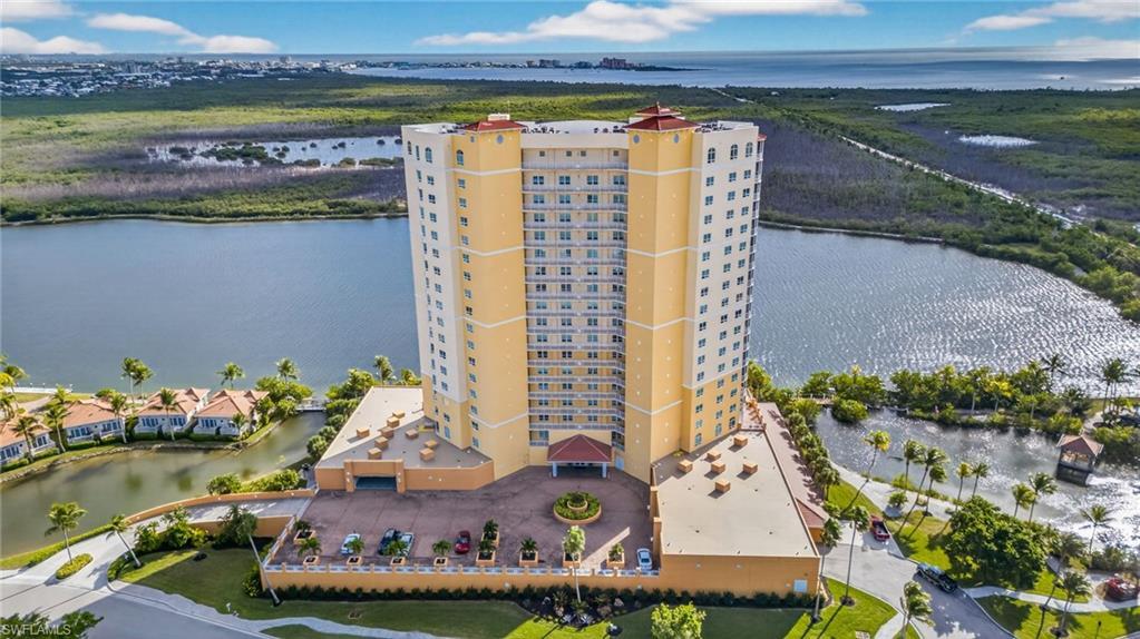 Image 1: Drone / aerial view of apartment complex / building and a nearby body of water