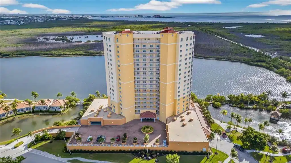 Image 1: Drone / aerial view of apartment complex / building and a nearby body of water