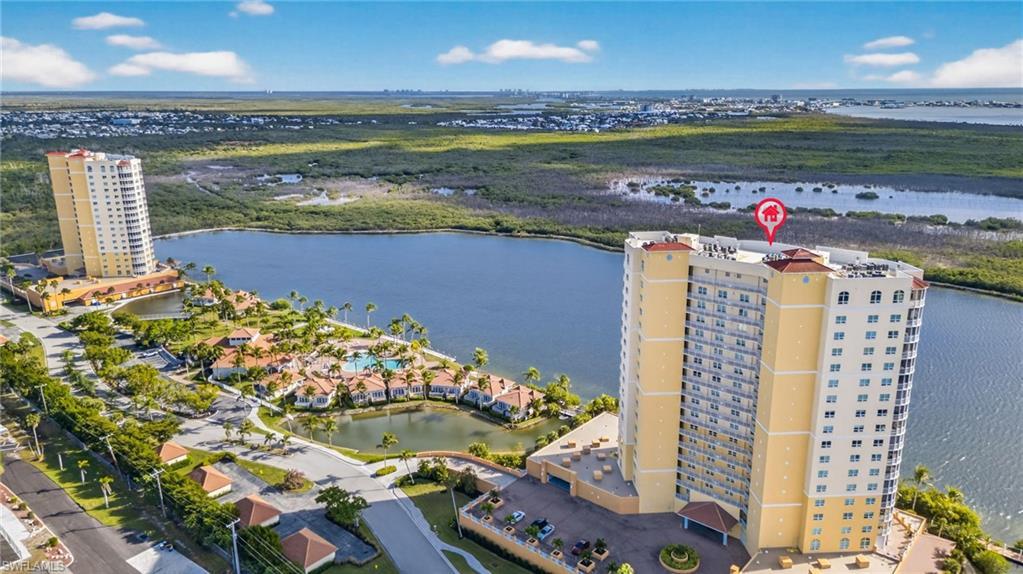 Image 2: Aerial view of apartment complex and a large body of water