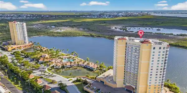 Image 2: Aerial view of apartment complex and a large body of water