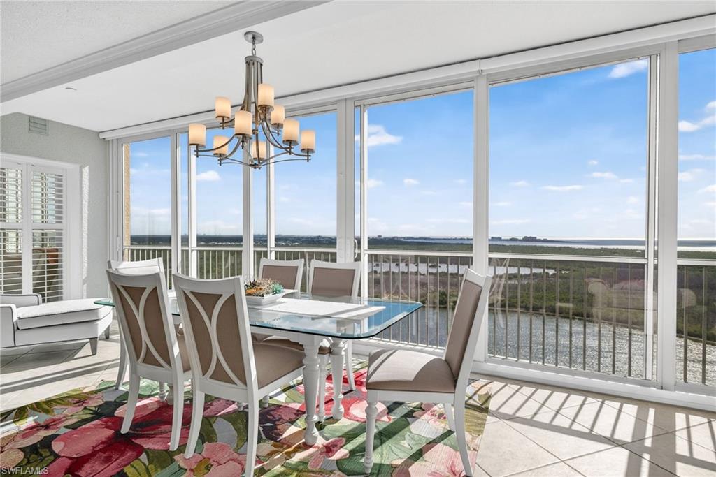 Image 4: Sunroom with a water view and a chandelier