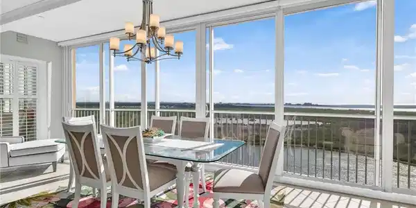 Image 4: Sunroom with a water view and a chandelier