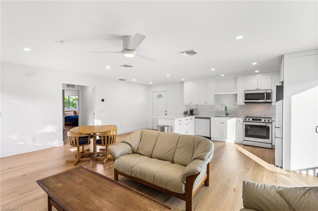 Image 2: Living room featuring recessed lighting, ceiling fan, and light wood flooring
