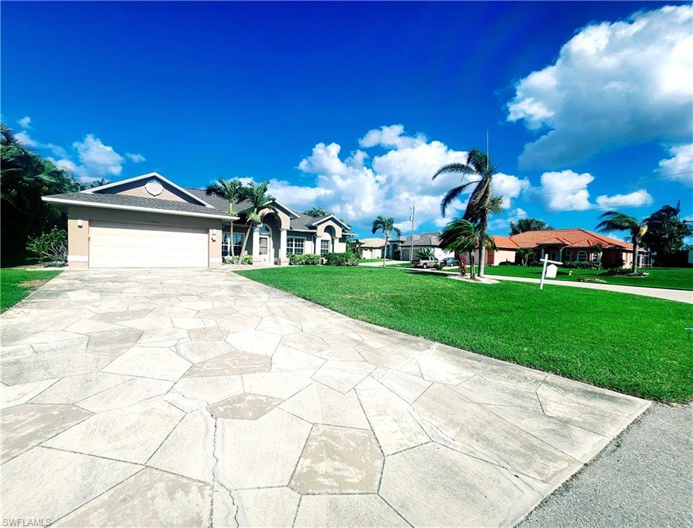 Image 1: Ranch-style home with a front lawn, concrete driveway, and a garage