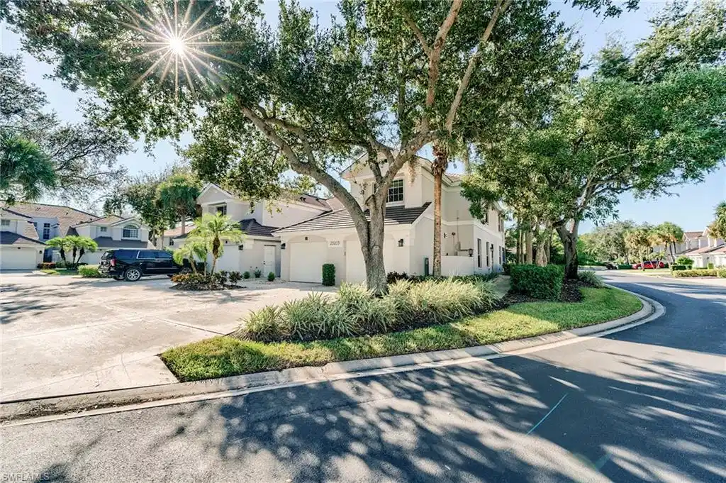 Image 1: View of front facade featuring a residential view, a garage, stucco siding, and driveway