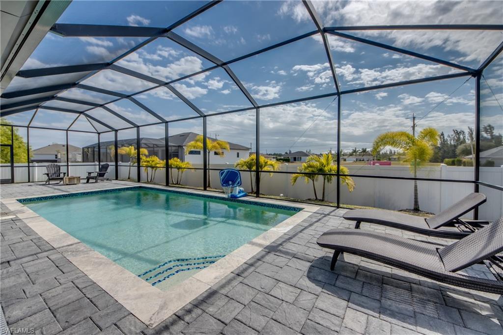Image 3: View of pool featuring a sunroom, a lanai, and a fenced backyard
