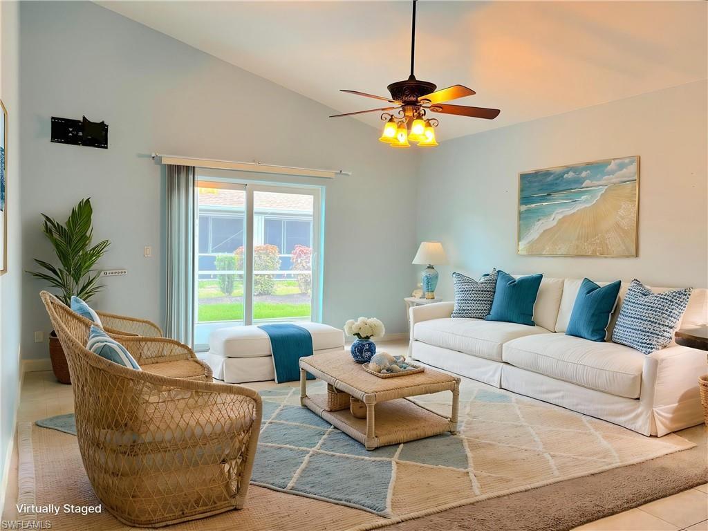 Image 3: Living area with vaulted ceilings, a ceiling fan with integrated lighting, and tile flooring