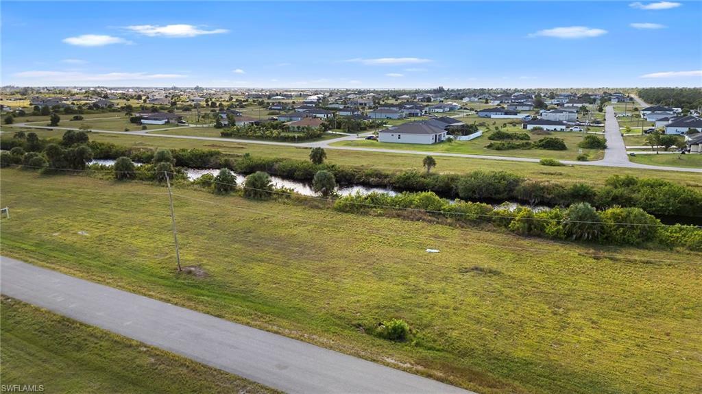 Image 1: View of rural area featuring nearby suburban area