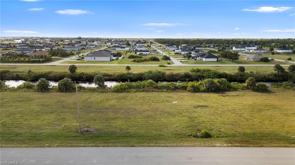Image 2: Aerial view of residential area with a large body of water