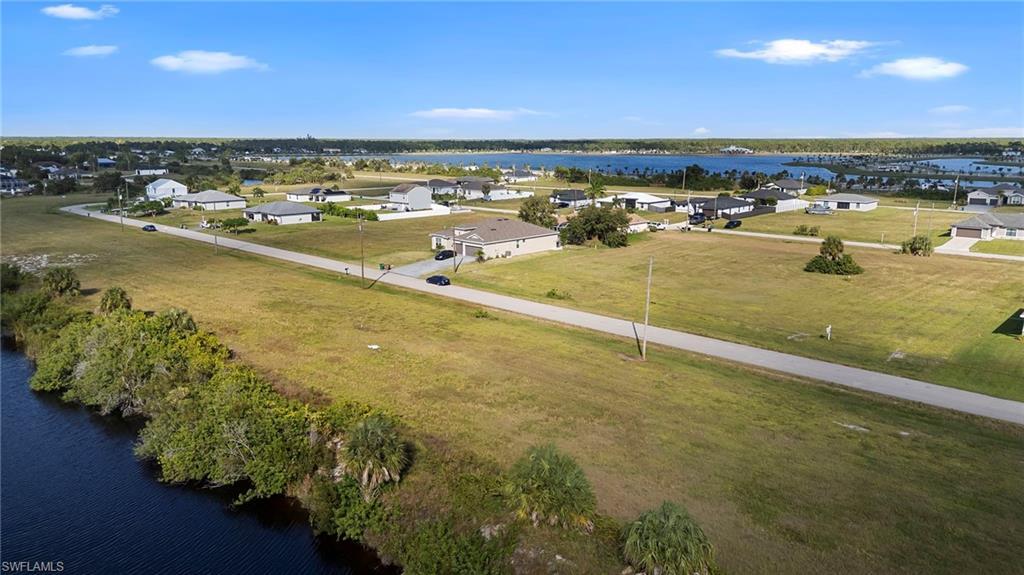 Image 4: Aerial perspective of suburban area with a nearby body of water