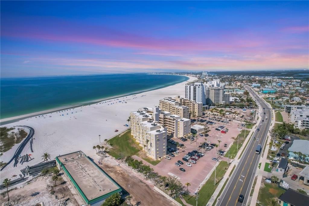 Image 1: Aerial view at dusk with a beach and water view