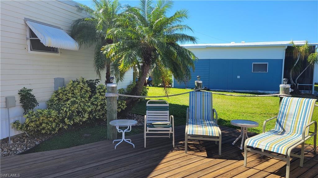 Image 2: Wooden deck featuring a yard