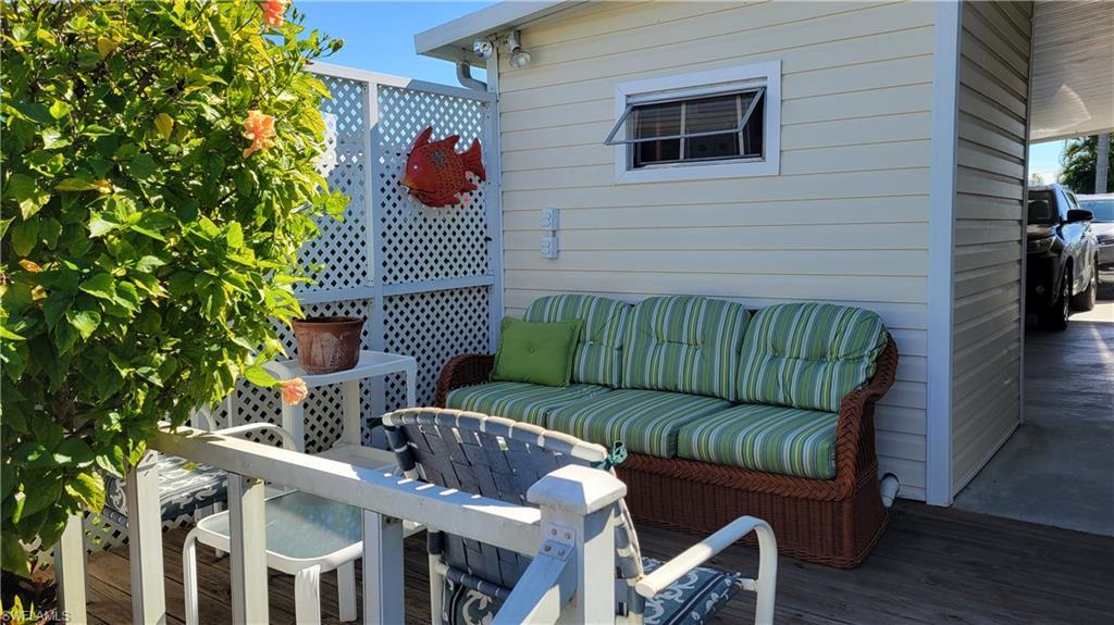 Image 4: Wooden deck with outdoor lounge area