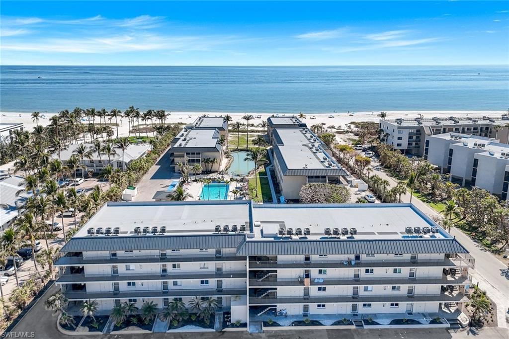 Image 2: Drone / aerial view with a water view and a view of the beach