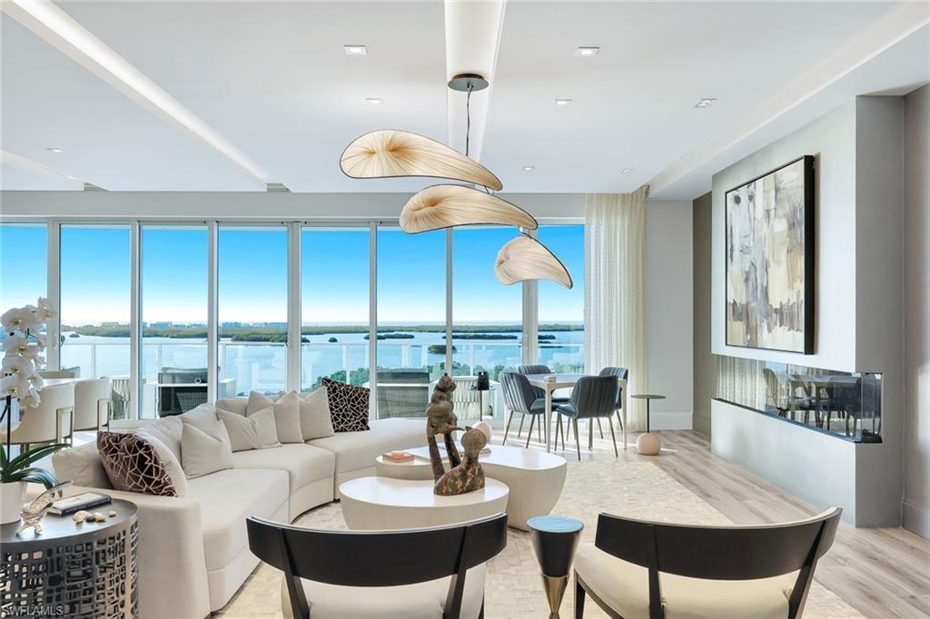 Image 3: This home's grand open-concept living space offers a seamless blend of sophistication, comfort, and sweeping vistas beyond.