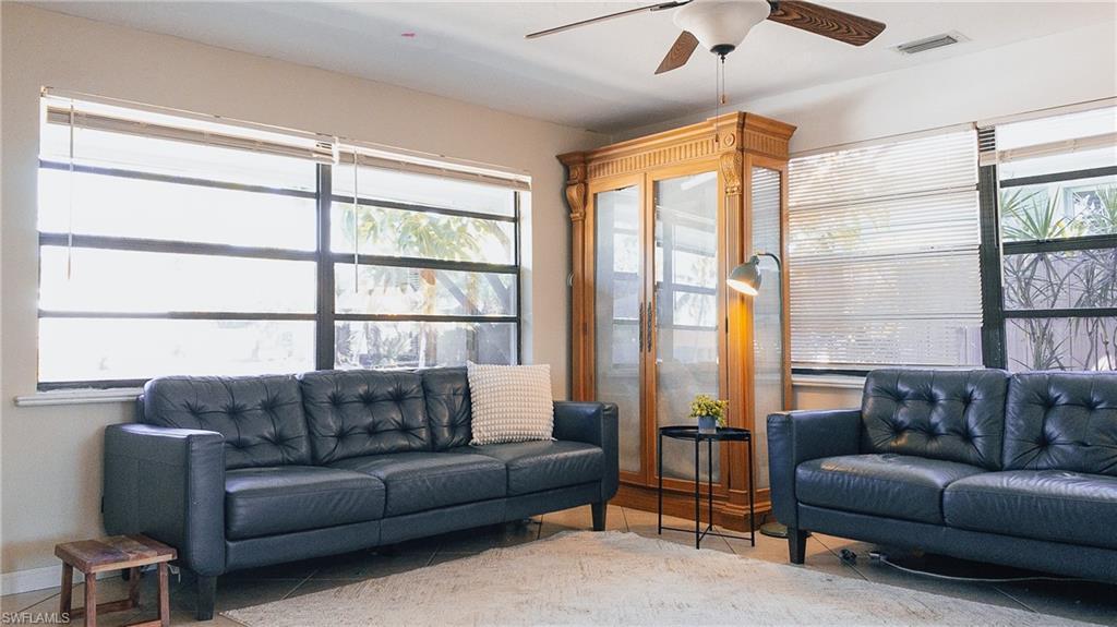 Image 4: Tiled living room with ceiling fan and baseboards