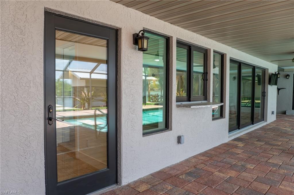 Image 4: View of exterior entry featuring stucco siding