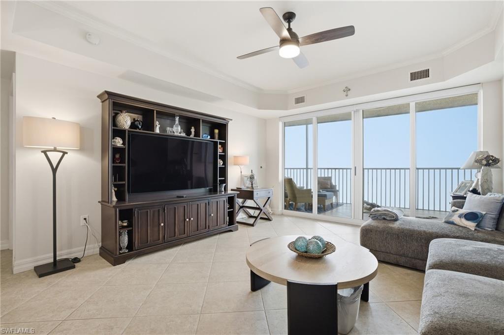 Image 4: Living room featuring light tile patterned flooring, crown molding, and a ceiling fan