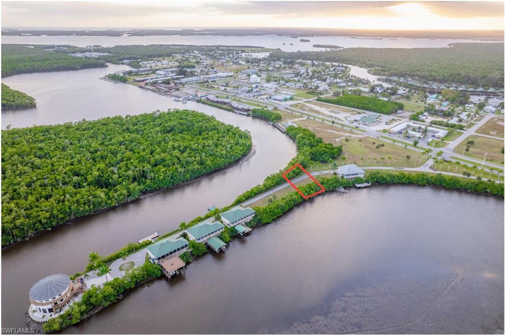 Image 1: Drone / aerial view of Everglades City and a large body of water surrounding property