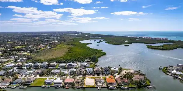 Image 4: Aerial view of residential area featuring a large body of water