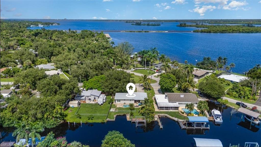 Image 1: Aerial perspective of suburban area featuring a large body of water