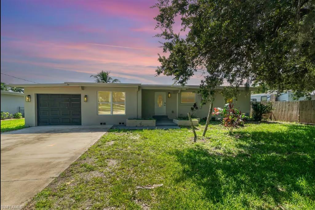 Image 2: Single story home featuring stucco siding, an attached garage, and driveway