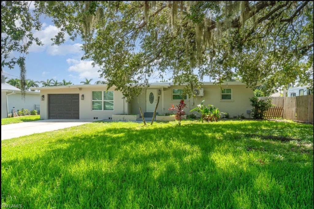 Image 3: Ranch-style home featuring an attached garage, concrete driveway, and stucco siding