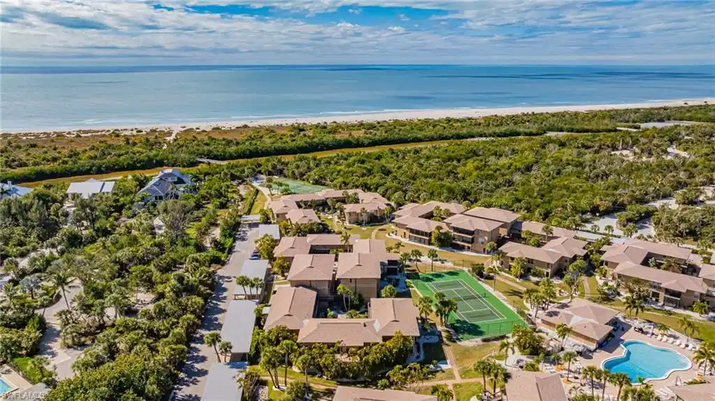 Image 1: Aerial view of residential area featuring a large body of water