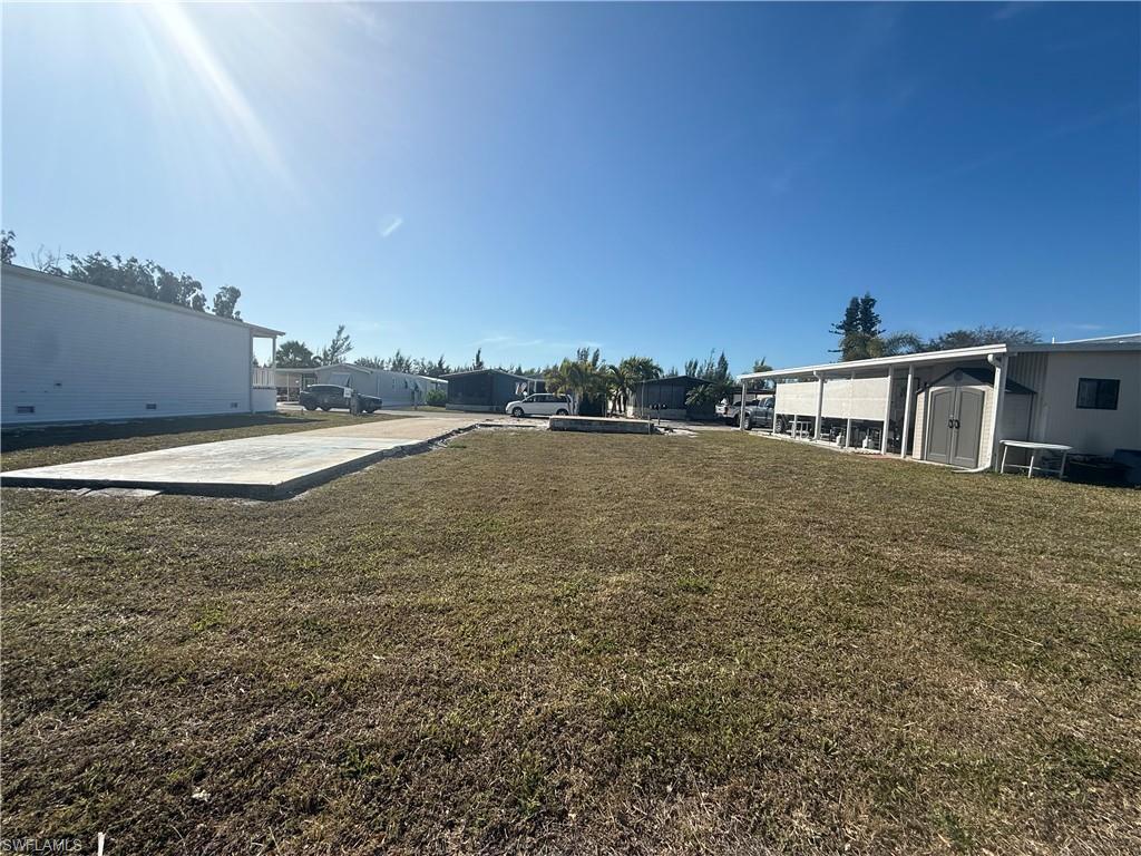 Image 4: View of grassy yard featuring a shed