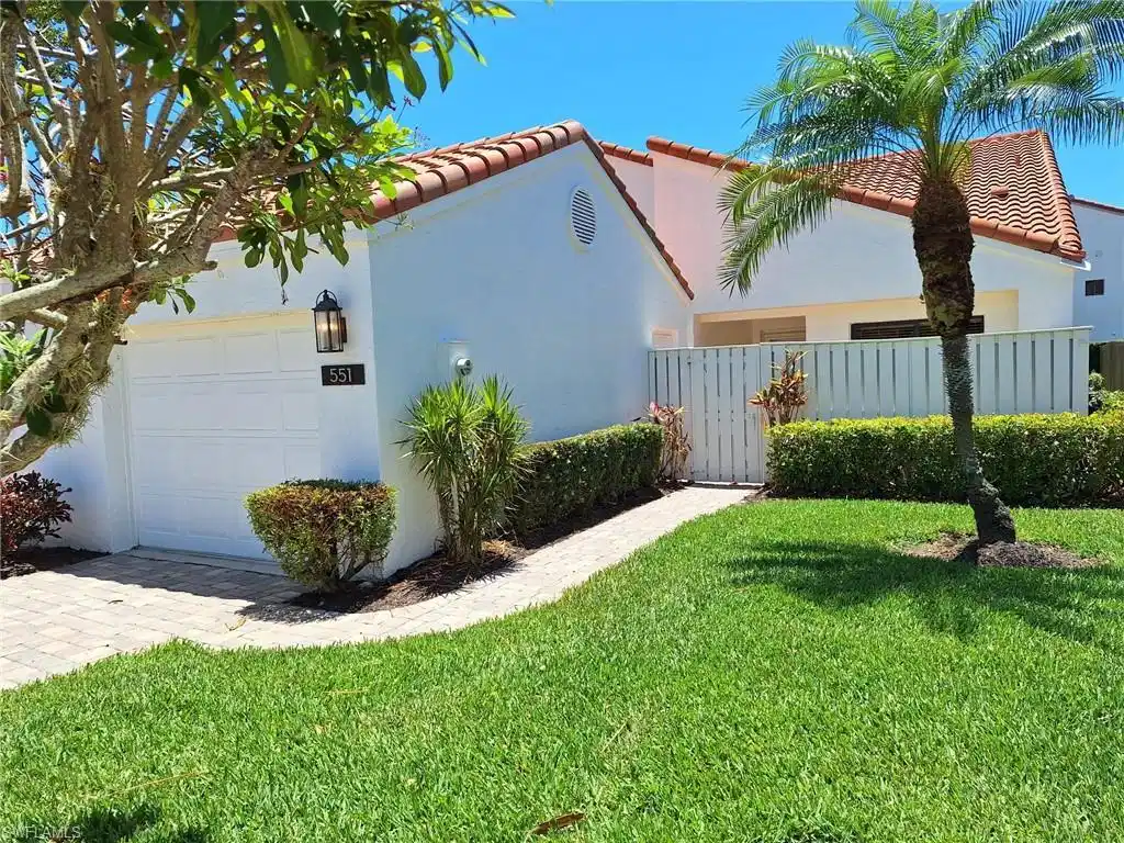 Image 1: View of home's exterior featuring a garage and a yard
