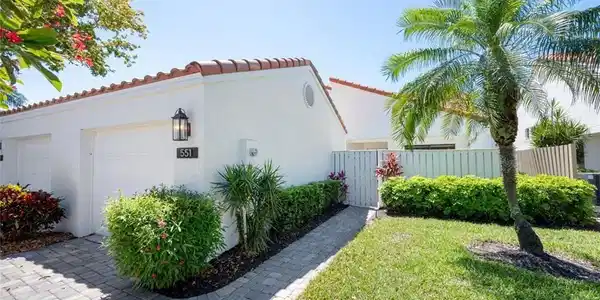 Image 2: View of property exterior featuring a lawn area