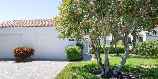 Image 3: View of front of home featuring a garage and a front lawn