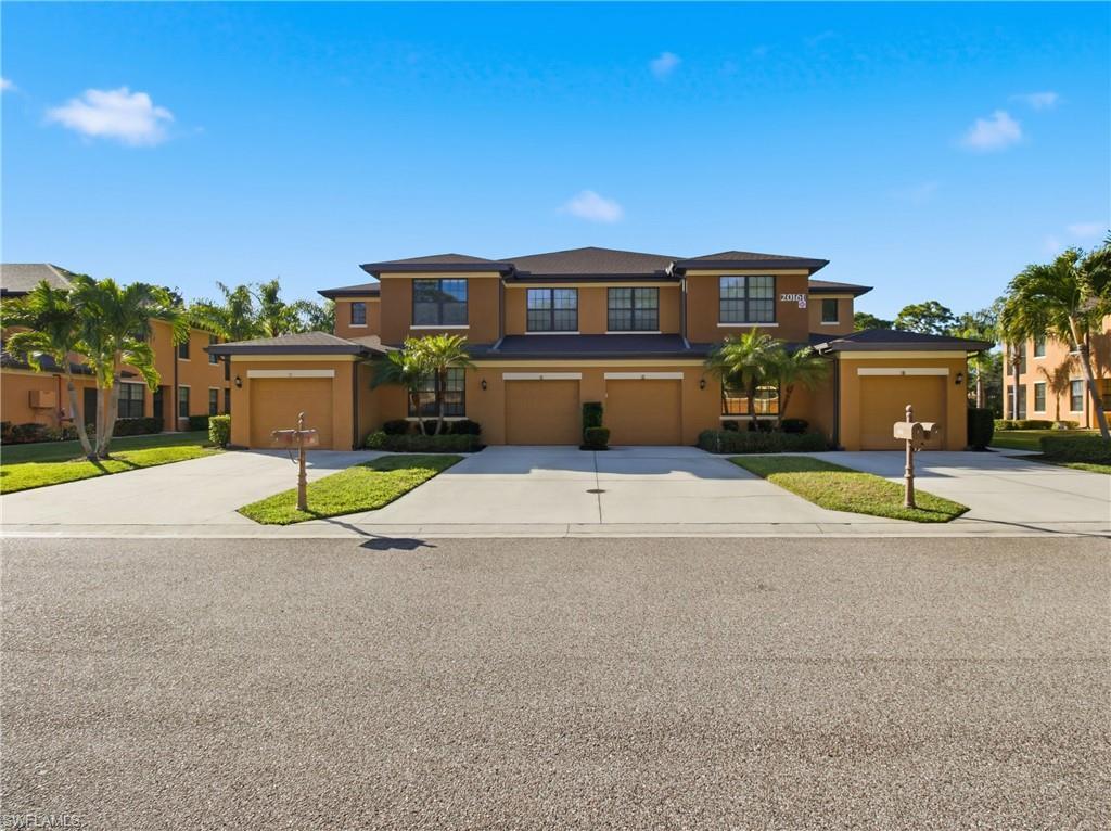 Image 2: View of front of house featuring stucco siding, driveway, and a garage