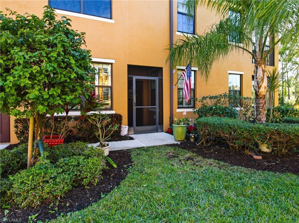 Image 4: Entrance to property with a yard and stucco siding