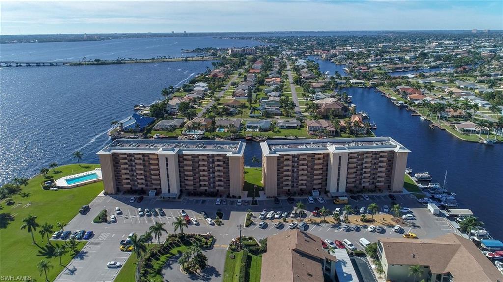 Image 1: Bird's eye view of a large body of water and apartment complex / building