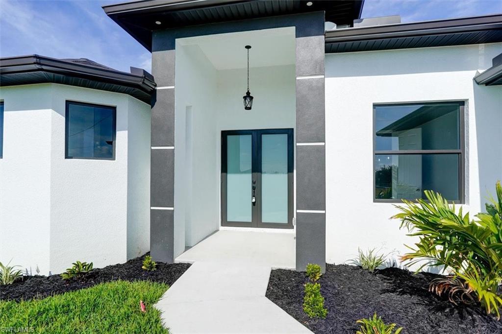 Image 3: Entrance to property featuring french doors and stucco siding