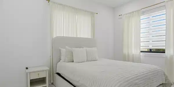 Image 2: Bright room featuring recessed lighting, a window with horizontal blinds and sheer curtains, and tile flooring