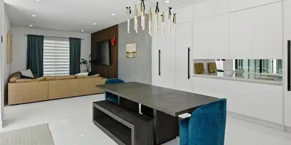 Image 4: Open-concept living space featuring high-gloss white tile flooring