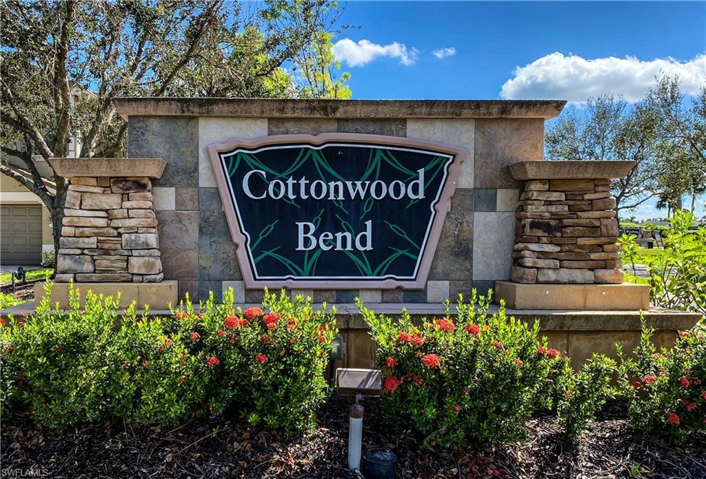 Image 1: Community entrance sign featuring stacked stone columns and a textured stone facade