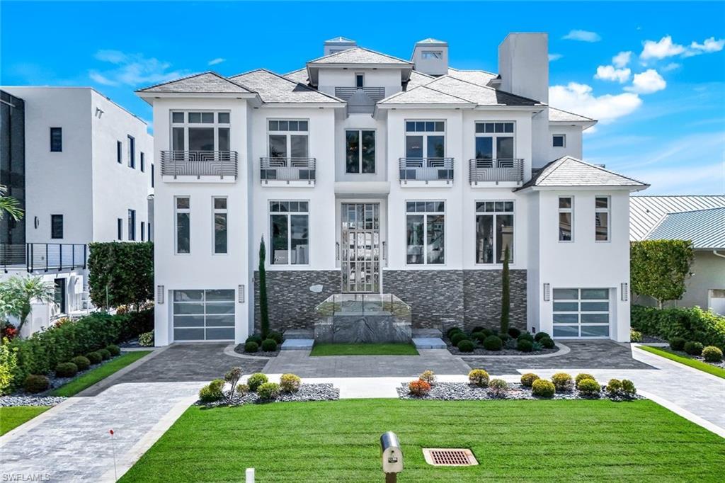 Image 1: Granite driveway, Thassos marble decks, stainless railings by Zynda Custom Homes.