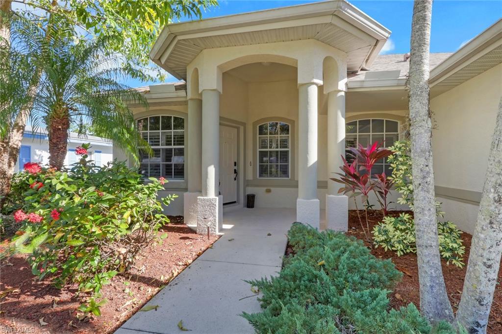 Image 1: Doorway to property featuring stucco siding and a porch