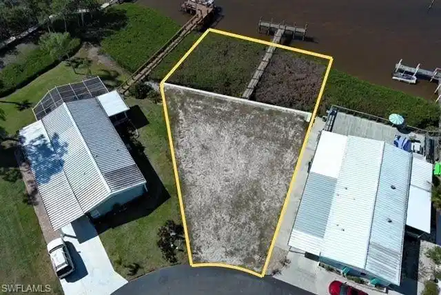Image 1: Aerial view of property and surrounding area featuring property parcel outlined