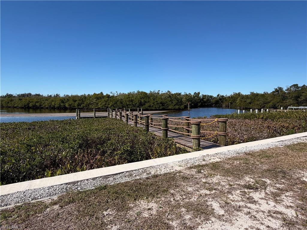 Image 3: Dock featuring a water/bay view