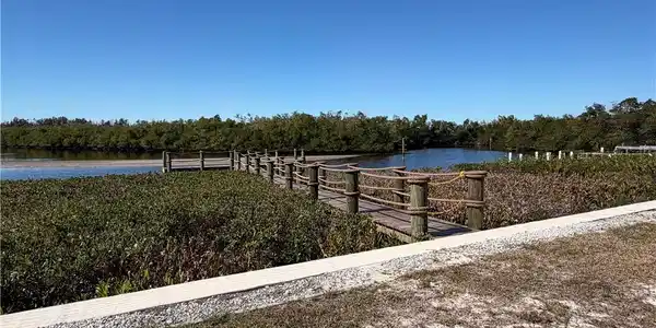 Image 3: Dock featuring a water/bay view