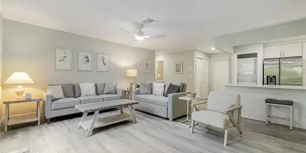Image 4: Great room featuring light wood-style flooring, a ceiling fan, and stacked washer / drying machine